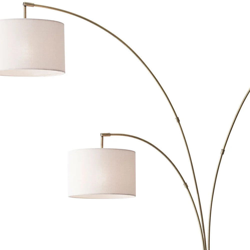 74" Brass Three Light Arc Floor Lamp With Off White Fabric Drum Shade-Floor Lamps-DECOROLALA